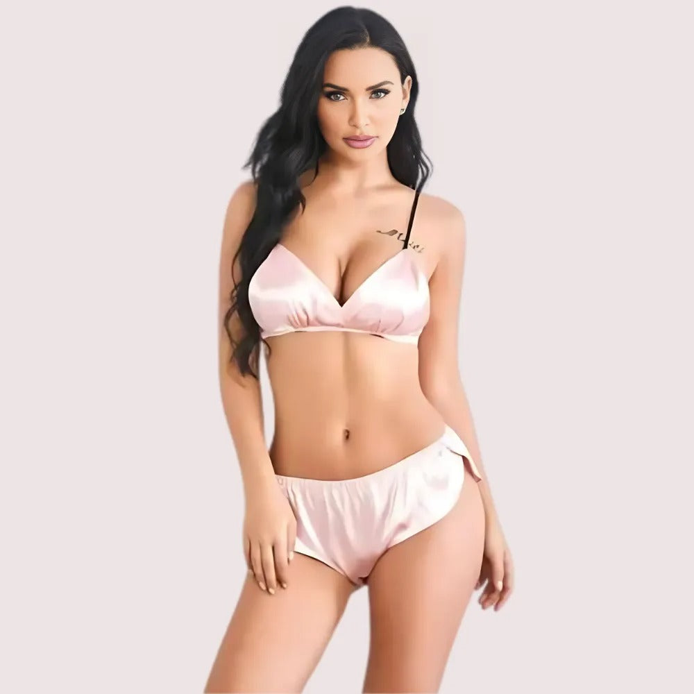 Woman wearing a fashionable pure silk bra and panty set in soft pink color, front view. - KozyKlicks