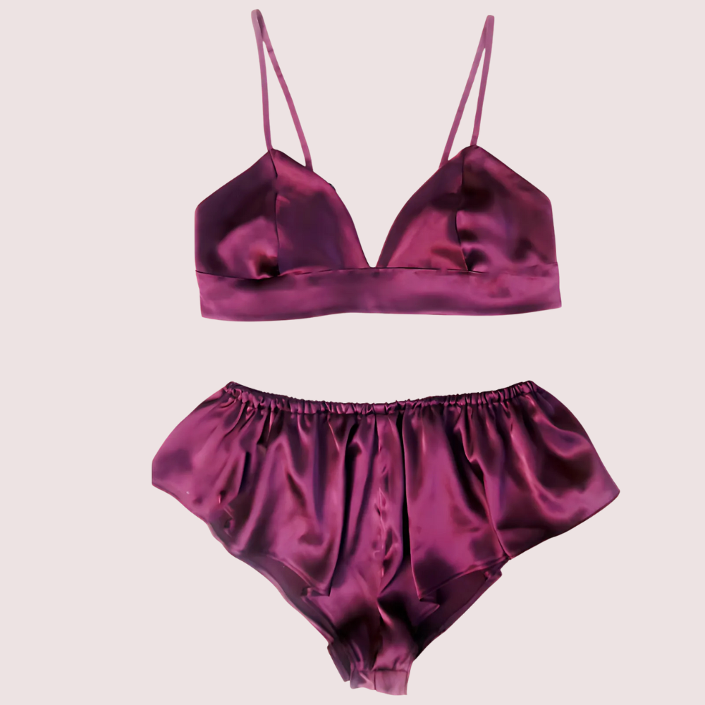 Flat lay of pure silk bra and matching high-waist shorts set in deep plum, showcasing silky sheen and lightweight breathable fabric.
