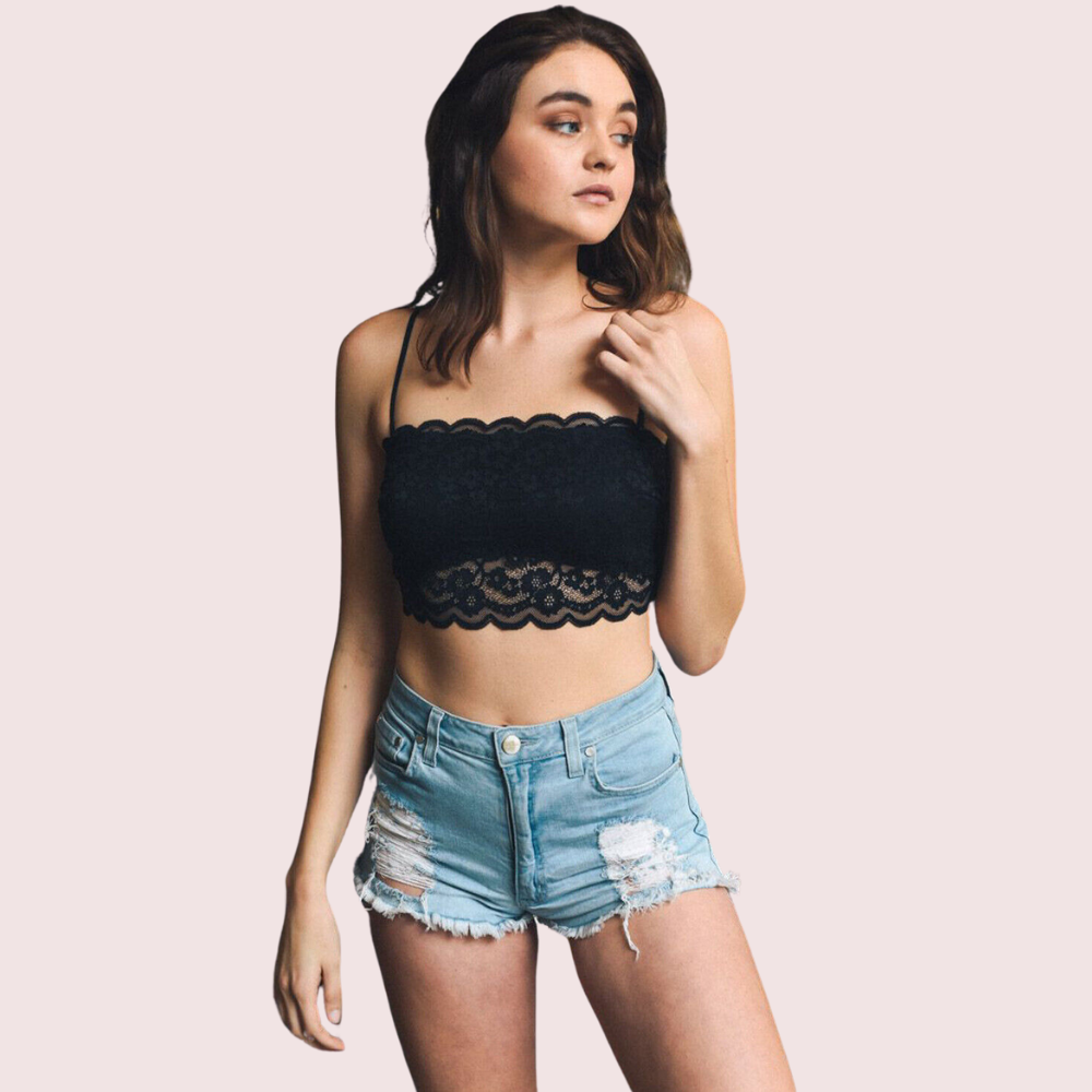 KozyKlicks flirty and feminine black lace bandeau bralette with scalloped edges and thin straps, styled with casual denim shorts.