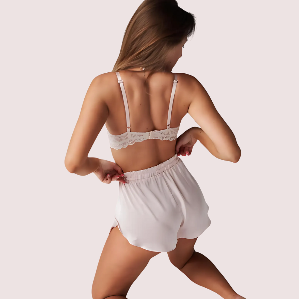 Back view of lace bralette and pure silk shorts set, showing adjustable straps and elastic high-waist shorts design.